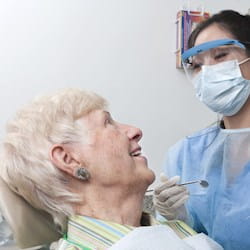 Dentist treating elderly lady