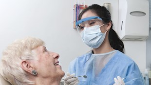 Dentist treating elderly lady