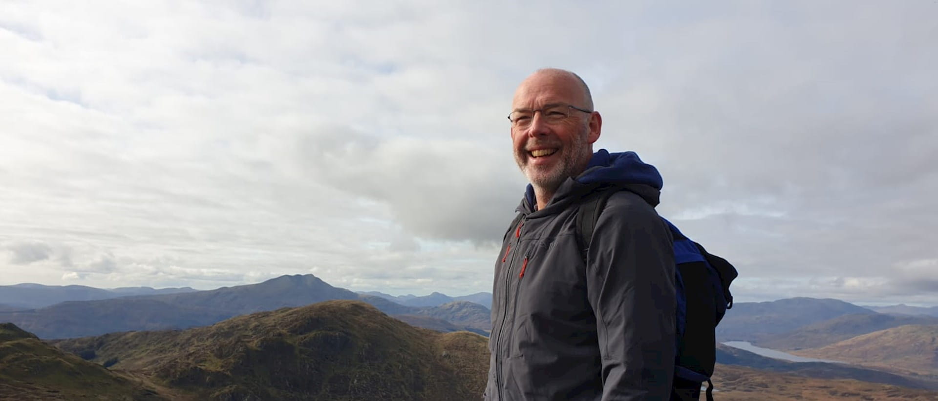 Photograph of Professor John Gibson walking in Scottish Mountains