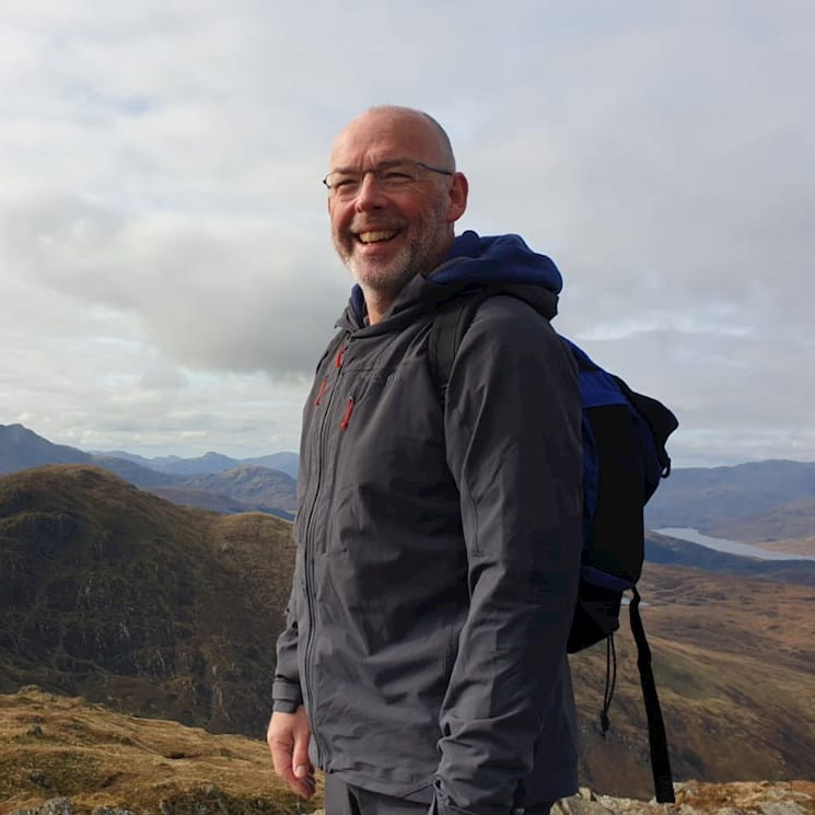Photograph of Professor John Gibson walking in Scottish Mountains