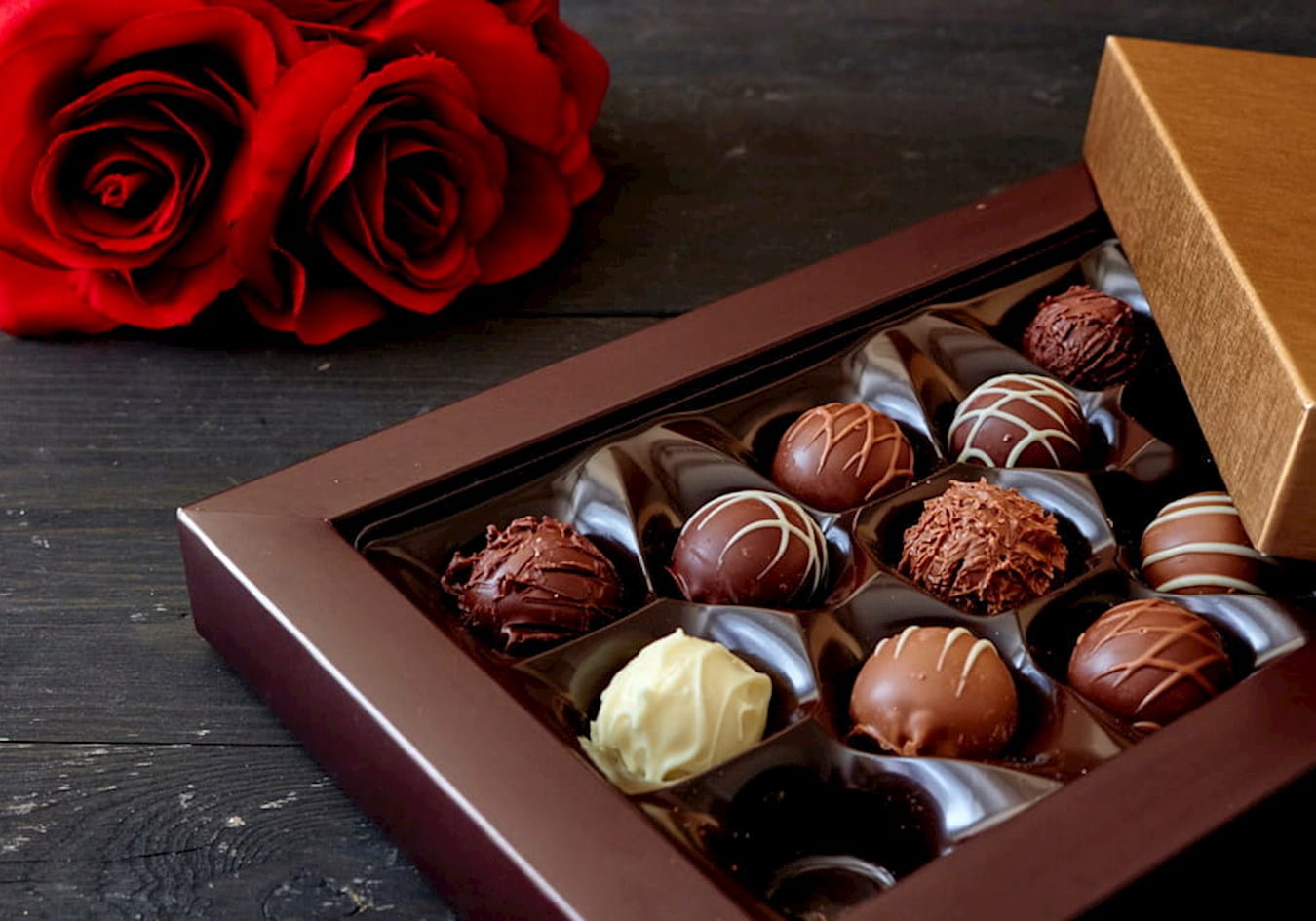 Photograph of chocolate box and roses