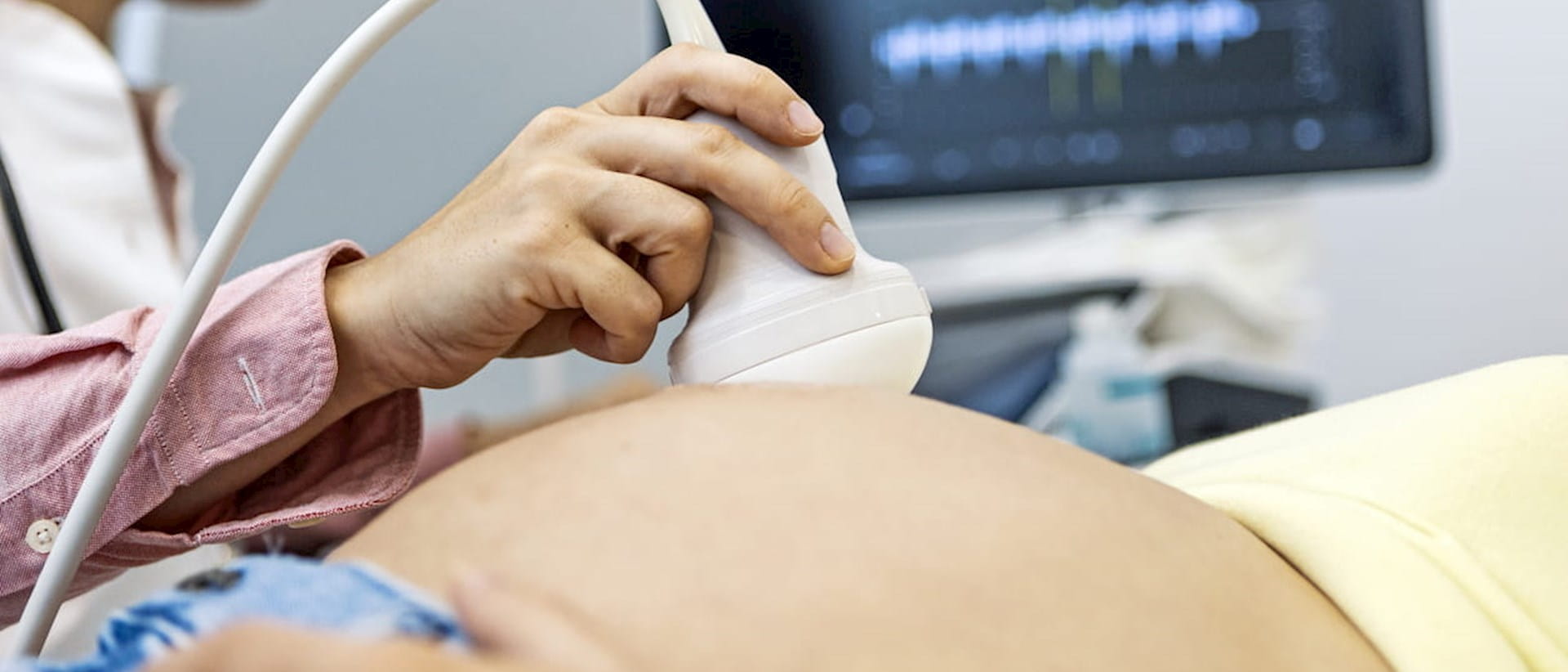 Photograph of pregnant patient undergoing ultrasound examination