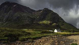 Photograph of white house in Scottish mountains