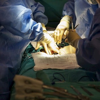 Surgeons performing caesarean section