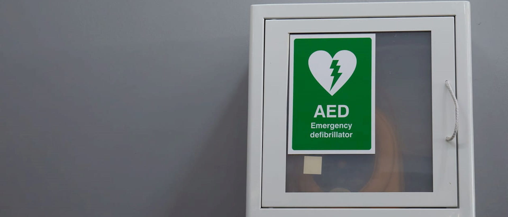 Photograph of defibrillator box on wall