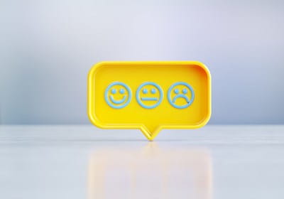 Speech bubble showing happy sad faces