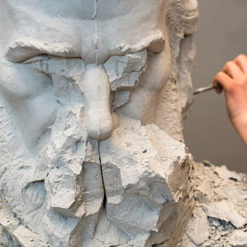 Sculptor carving statue