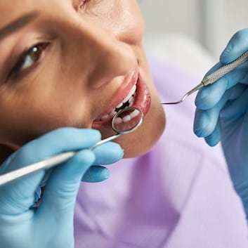Woman being examined by dentist