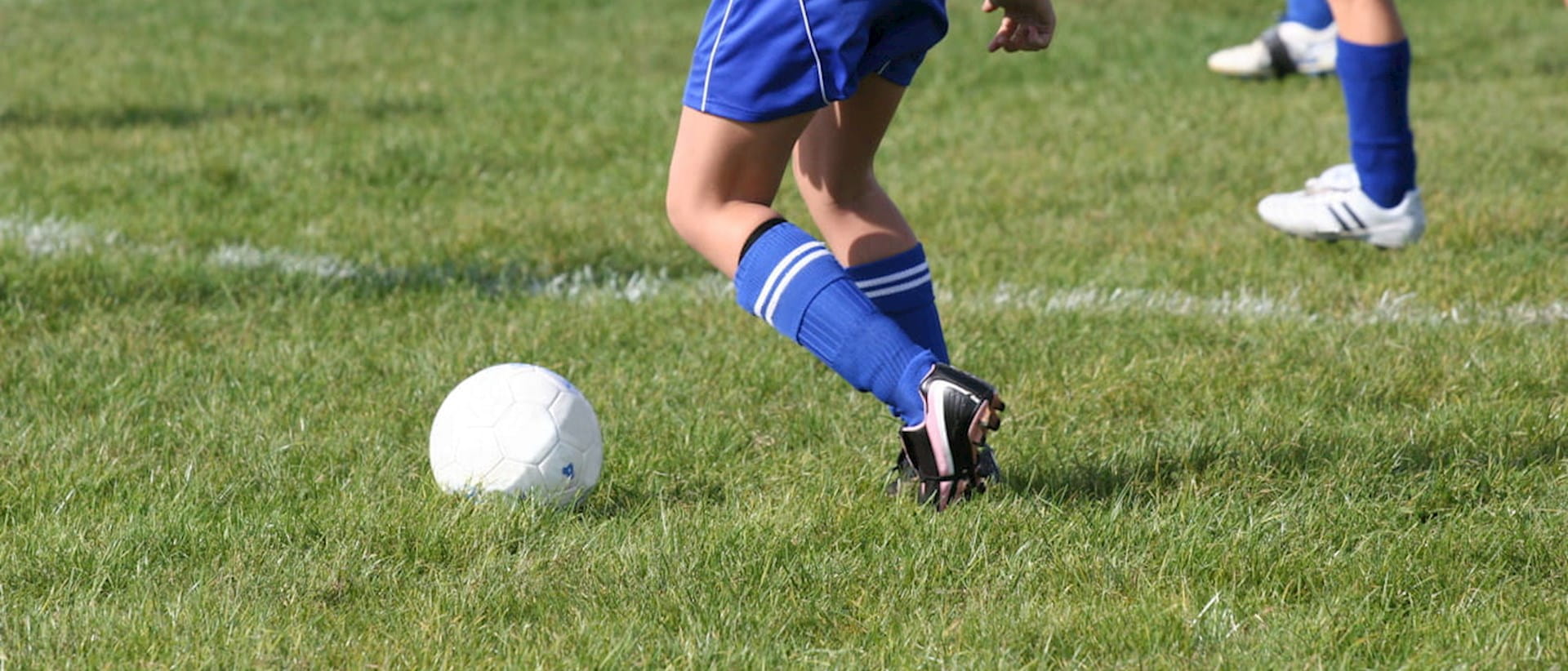 Teen girl playing football