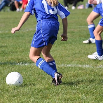 Teen girl playing football